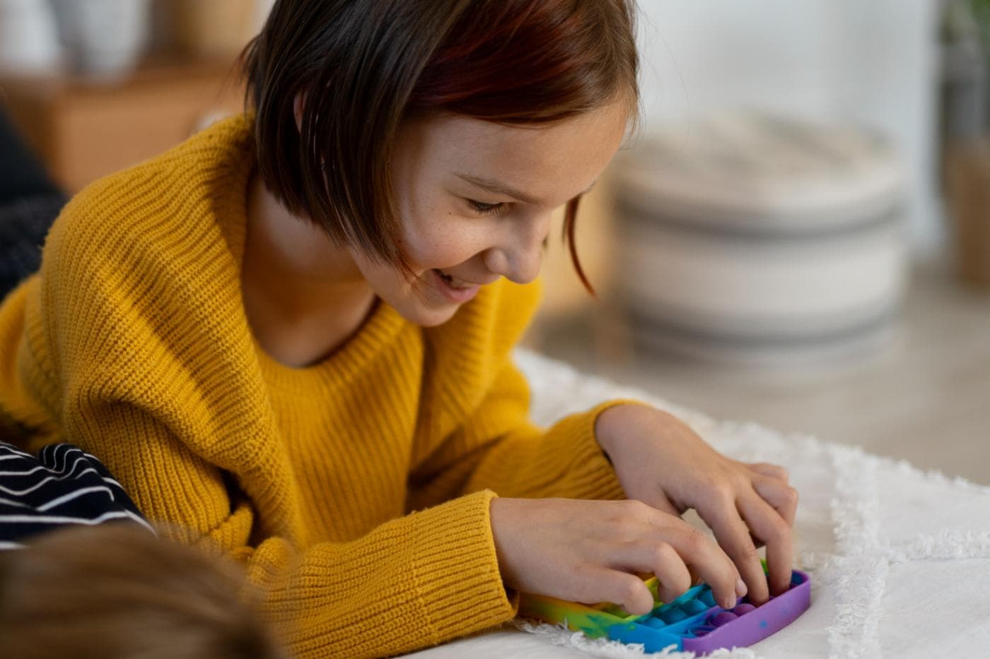 Parent sitting with child during a developmental activity
